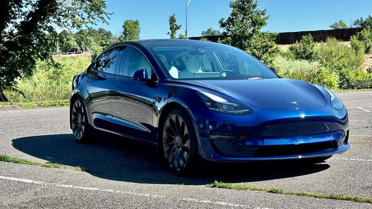 2023 Tesla Model 3 in blue parked outside,